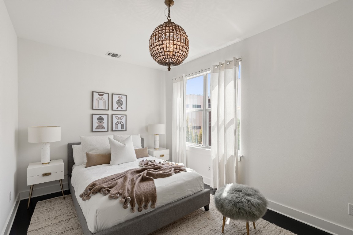 2105 Goodrich Avenue, Unit 2 Austin, TX 78704 - Photo 29 of 40 a bedroom with a bed and a chandelier