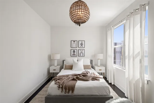 a bedroom with a bed and a window