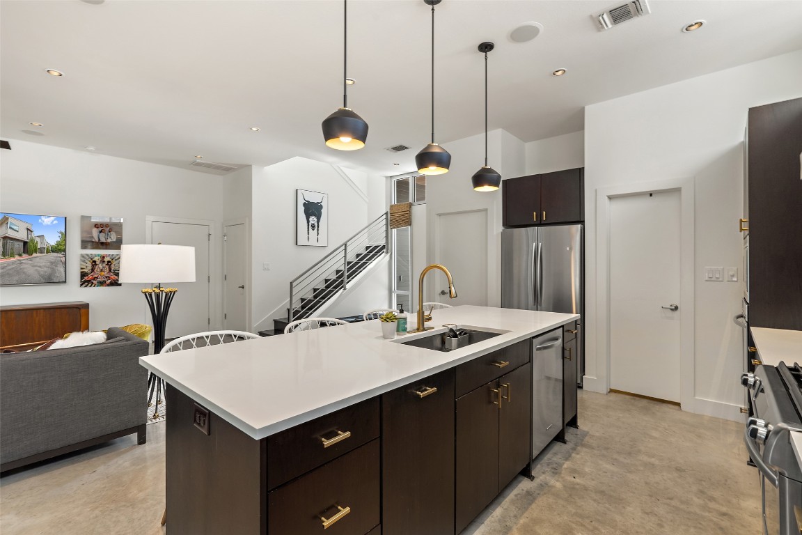 2105 Goodrich Avenue, Unit 2 Austin, TX 78704 - Photo 5 of 40 a kitchen with a stove a refrigerator a sink dishwasher with a dining table and chairs with wooden floor