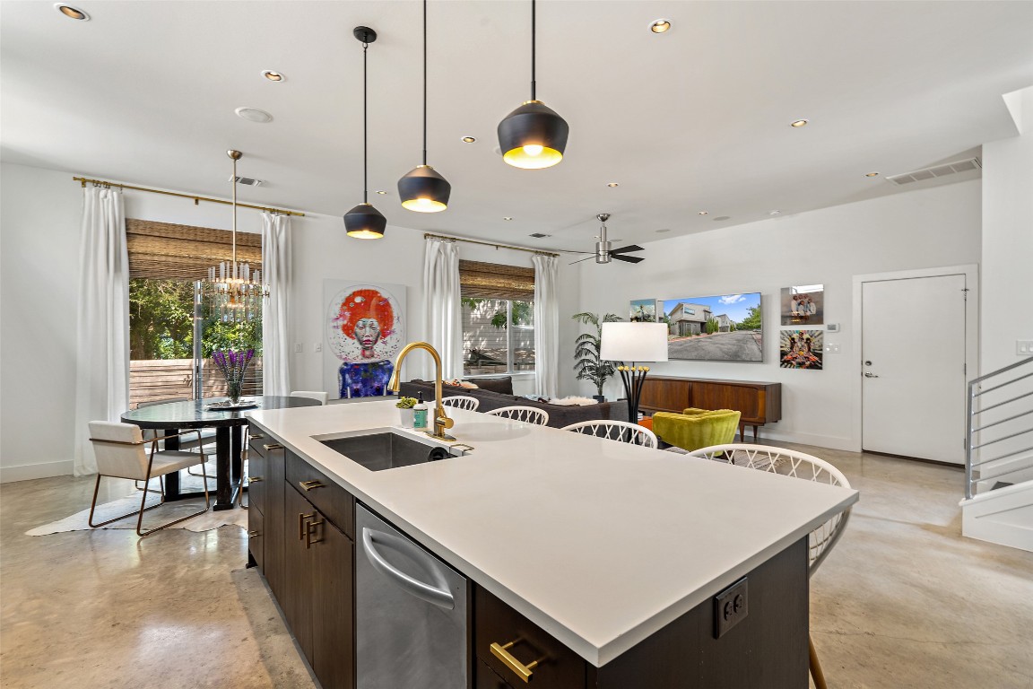2105 Goodrich Avenue, Unit 2 Austin, TX 78704 - Photo 6 of 40 a kitchen with a stove a kitchen island a dining table and chairs with wooden floor