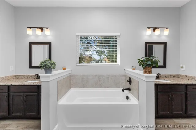 a bathroom with a granite countertop sink toilet and mirror