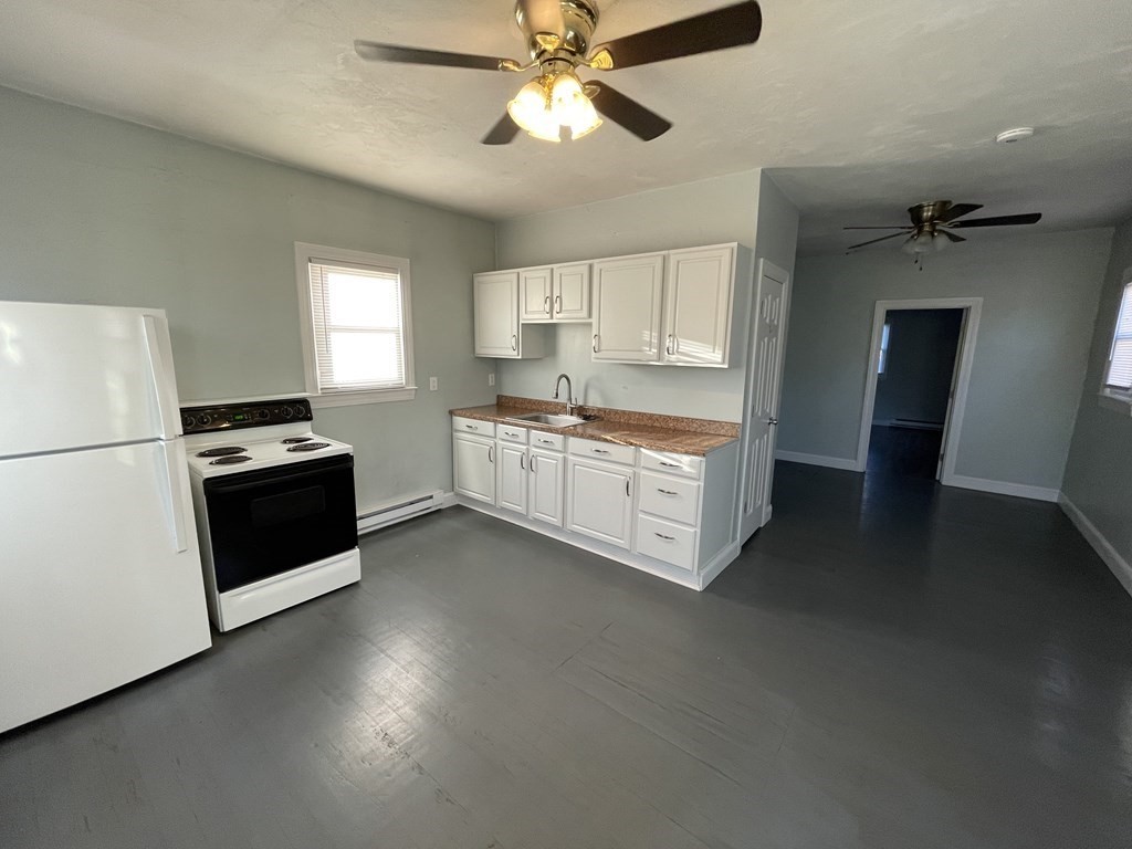 14 Hartford Avenue West, Unit 3 Uxbridge, MA 01569 - Photo 2 of 9 a kitchen with stainless steel appliances a stove a sink and a refrigerator