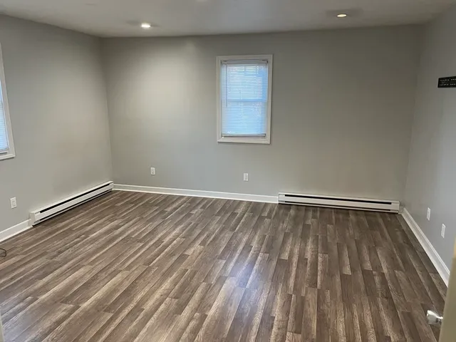 a view of a room with wooden floor