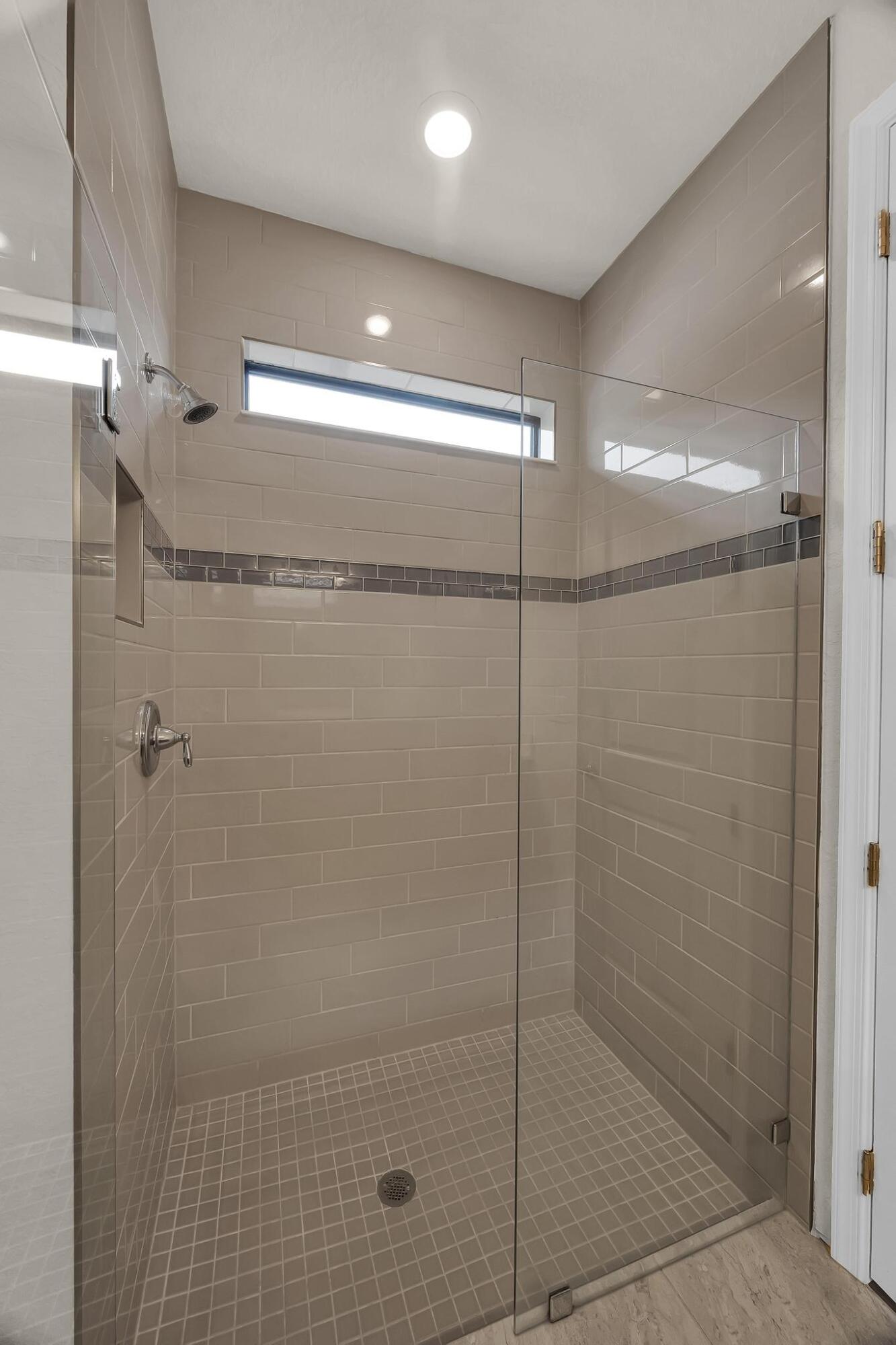 680 Southeast Villandry Way Port St. Lucie, FL 34984 - Photo 12 of 38 a bathroom with a shower