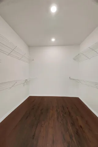 a view of a room with wooden floor