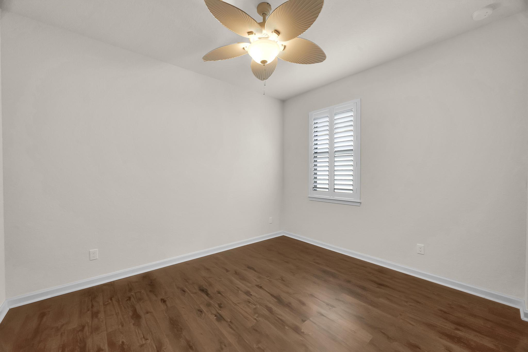 680 Southeast Villandry Way Port St. Lucie, FL 34984 - Photo 18 of 38 wooden floor in an empty room with a window
