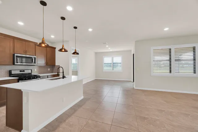 a kitchen with stainless steel appliances a refrigerator sink and microwave