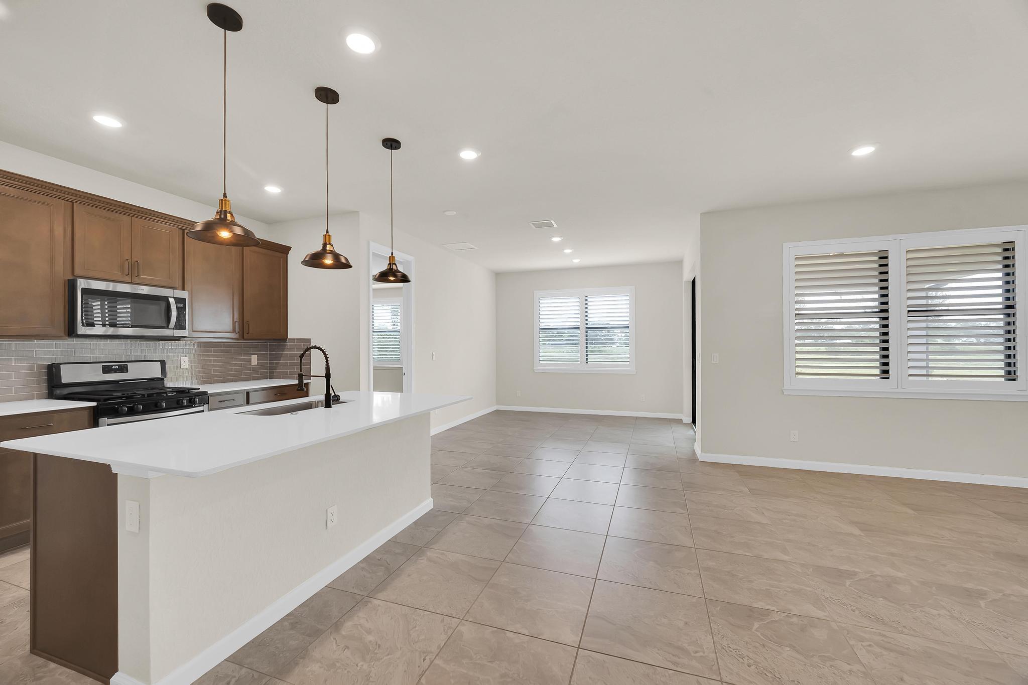 680 Southeast Villandry Way Port St. Lucie, FL 34984 - Photo 2 of 38 a kitchen with stainless steel appliances a refrigerator sink and microwave