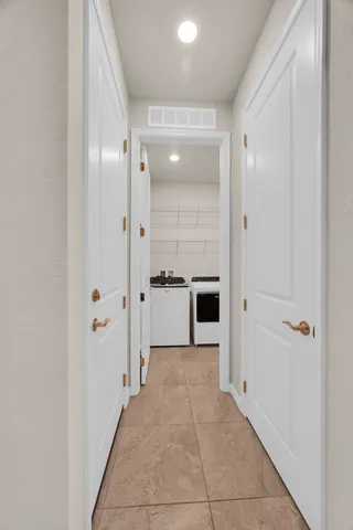 a bathroom with a glass shower door and a mirror