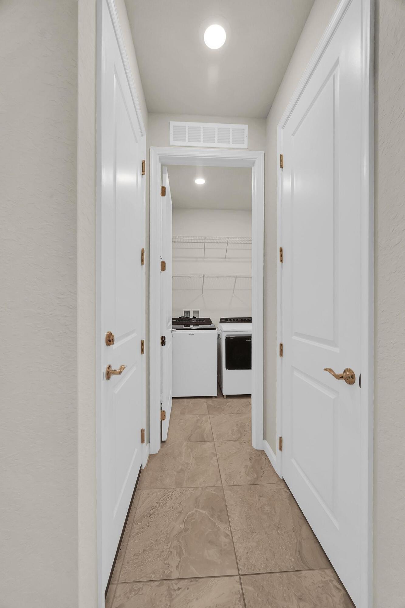 680 Southeast Villandry Way Port St. Lucie, FL 34984 - Photo 22 of 38 a bathroom with a glass shower door and a mirror