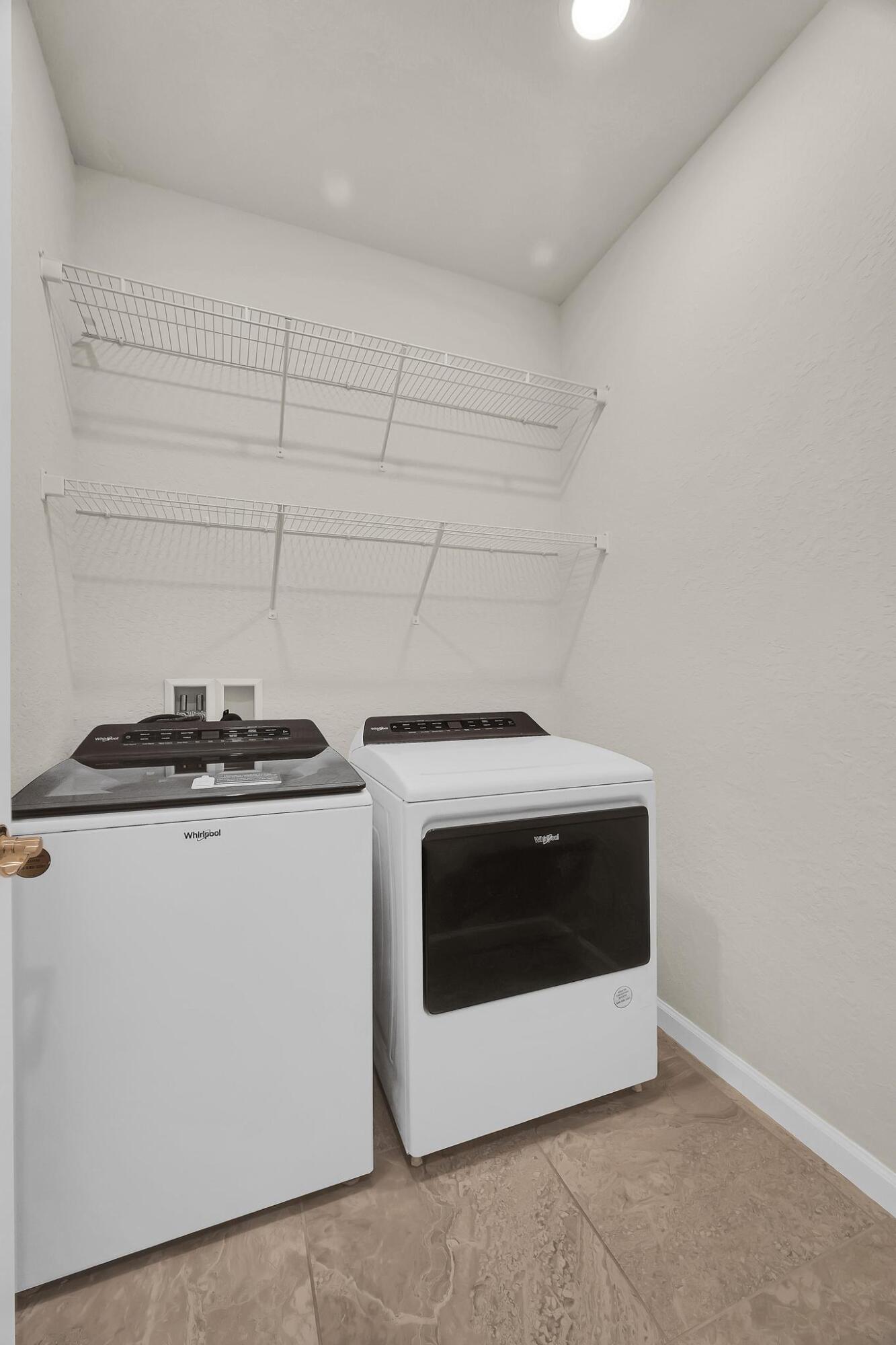 680 Southeast Villandry Way Port St. Lucie, FL 34984 - Photo 23 of 38 a utility room with washer and dryer
