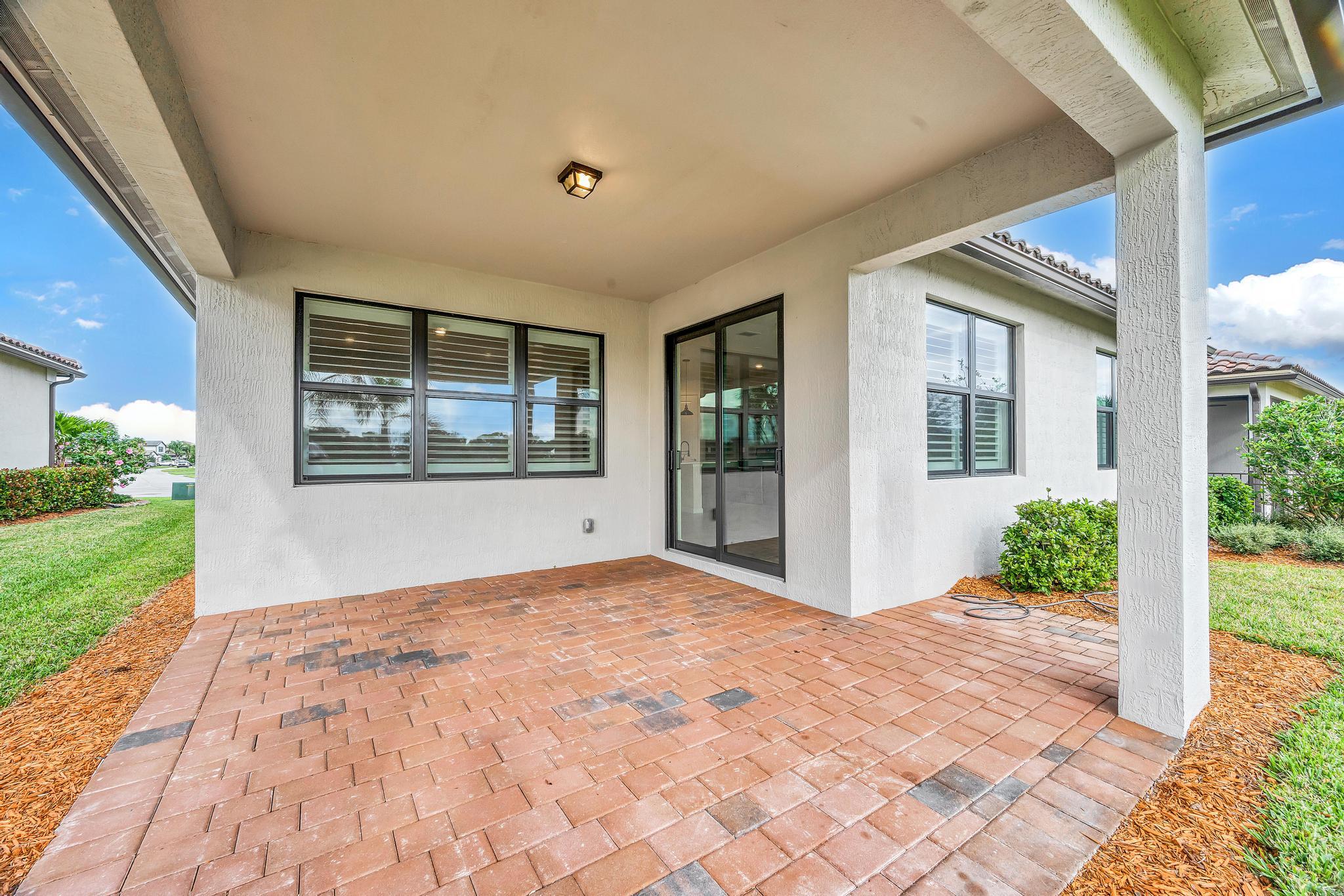 680 Southeast Villandry Way Port St. Lucie, FL 34984 - Photo 26 of 38 a view of an entrance gate with a garden