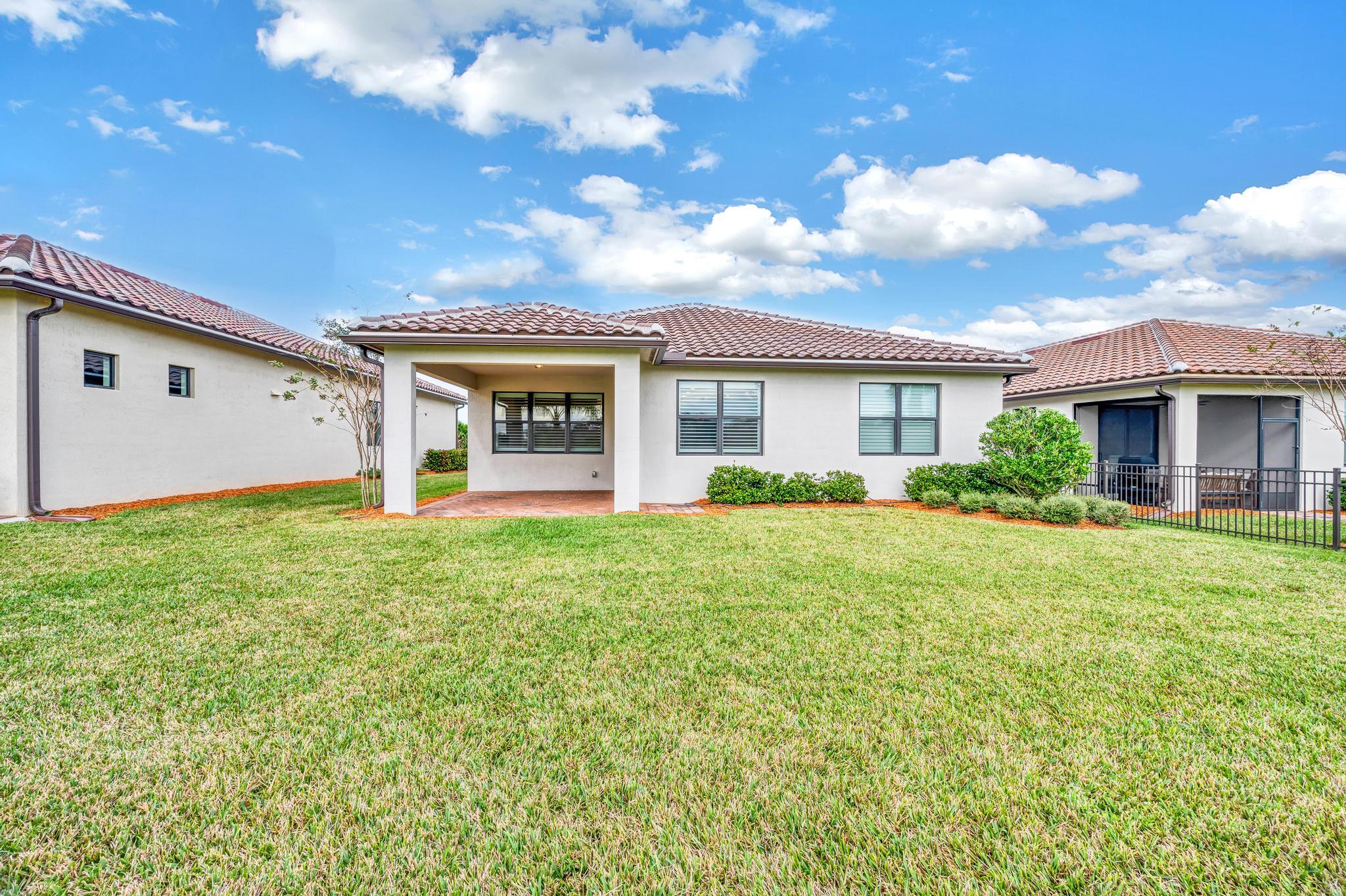 680 Southeast Villandry Way Port St. Lucie, FL 34984 - Photo 27 of 38 a view of a house with backyard and garden