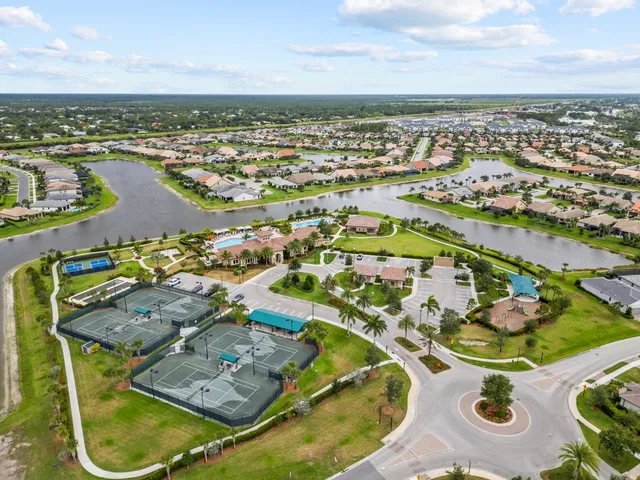 an aerial view of a swimming pool with outdoor seating