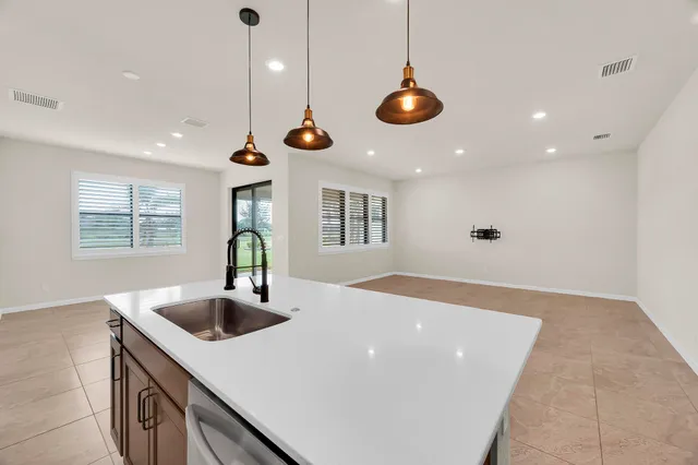 a kitchen with stainless steel appliances granite countertop a sink and a window