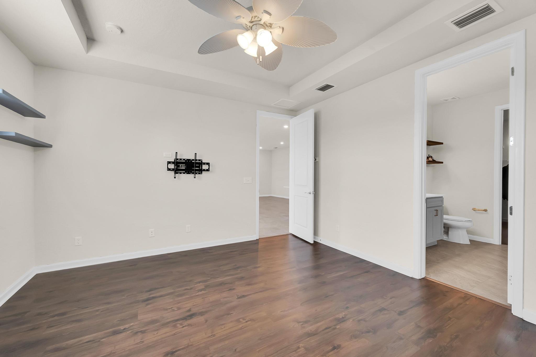 680 Southeast Villandry Way Port St. Lucie, FL 34984 - Photo 9 of 38 wooden floor in an empty room with a window