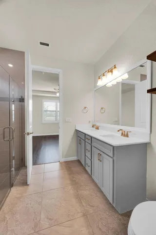 a spacious bathroom with a double vanity sink mirror and toilet