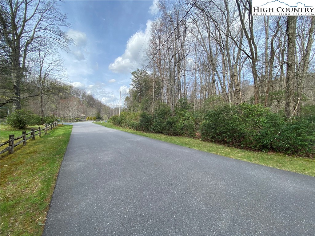 Sweetwater Ridge Burnsville, NC 28714 - Photo 16 of 39 a view of a field with trees on both side of it