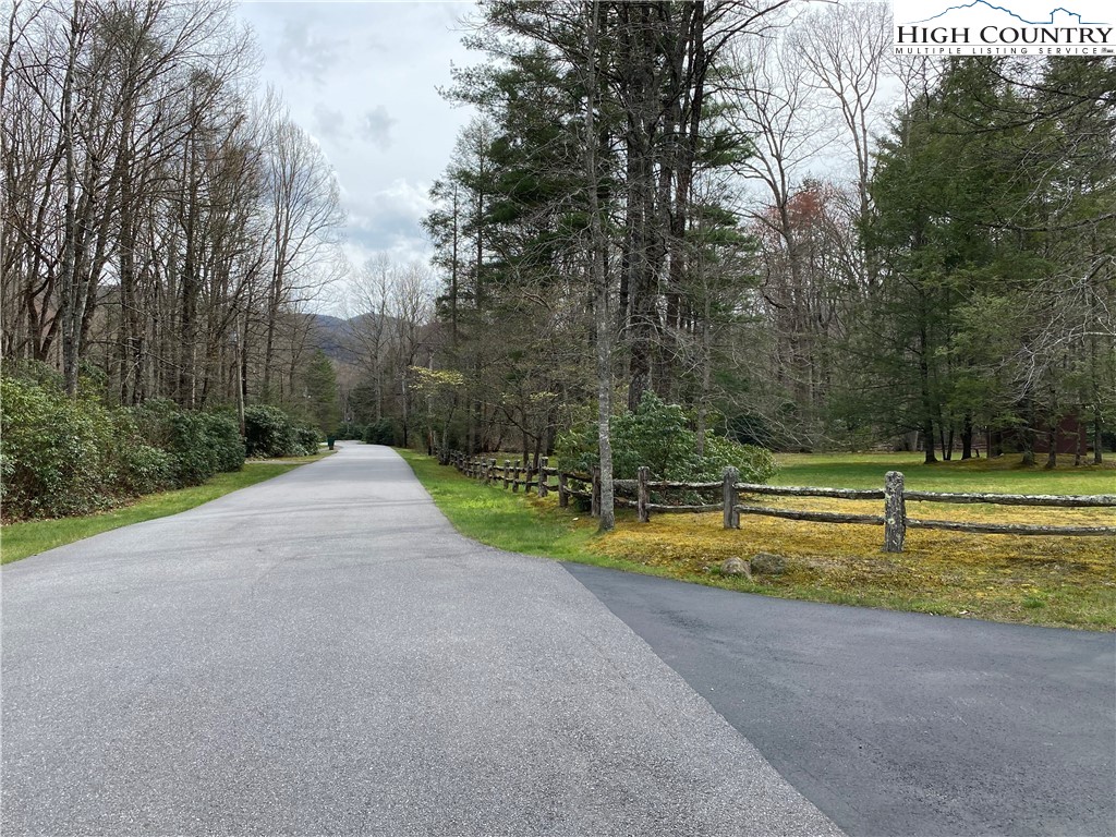 Sweetwater Ridge Burnsville, NC 28714 - Photo 9 of 39 a view of a swimming pool with a yard and large trees