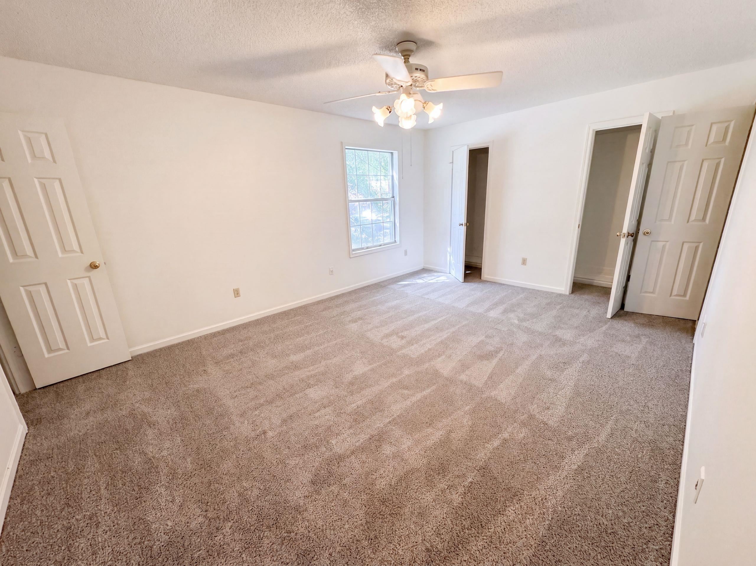 3798 Fern Ridge Road Memphis, TN 38115 - Photo 4 of 16 Bright interior with light-toned walls, neutral carpeting, and a ceiling fan with integrated lighting