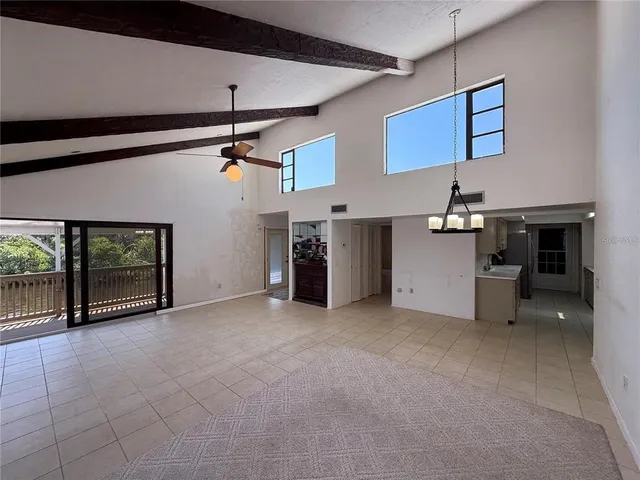 a view of empty room with fireplace and window