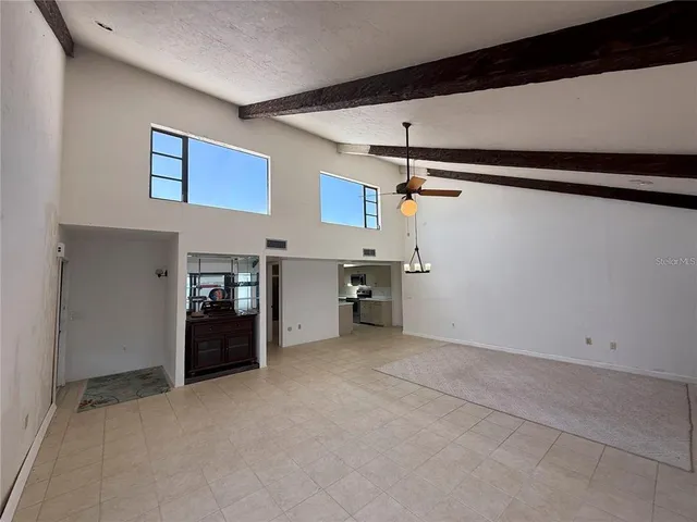 a large white kitchen with a sink and dishwasher a stove top oven with wooden floor