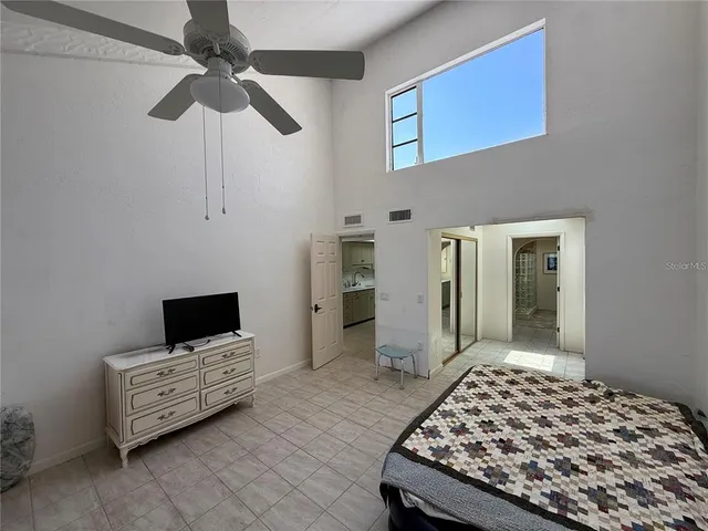 a bedroom with furniture and a chandelier