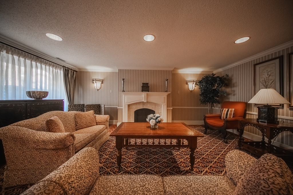 1002 Paradise Road, Unit PHE Swampscott, MA 01907 - Photo 21 of 23 a living room with furniture and a fireplace