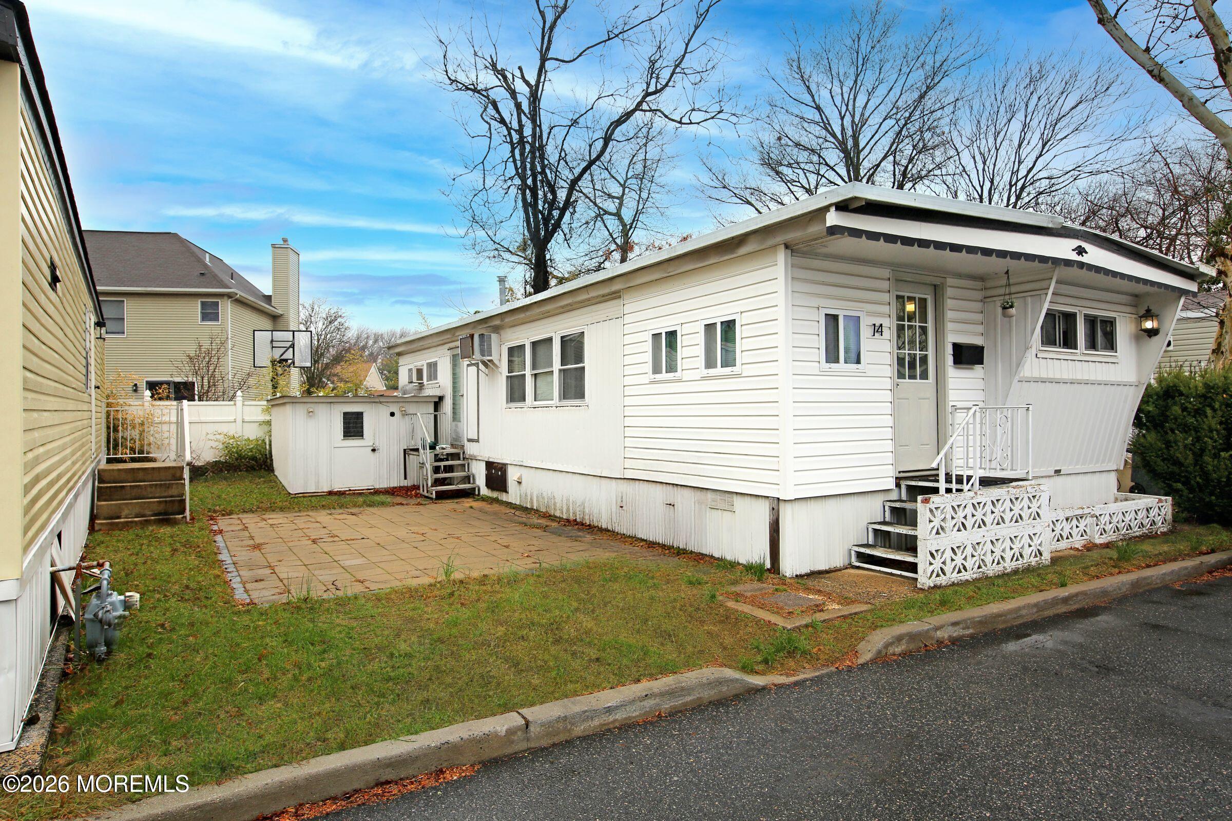 14 Monique Circle Hazlet, NJ 07730 - Photo 1 of 23 a view of a white house with a yard and garage