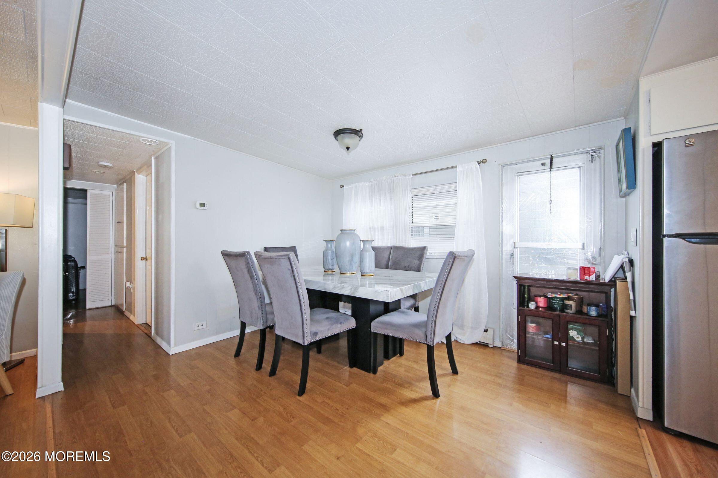 14 Monique Circle Hazlet, NJ 07730 - Photo 11 of 23 a view of a dining room with furniture window and wooden floor