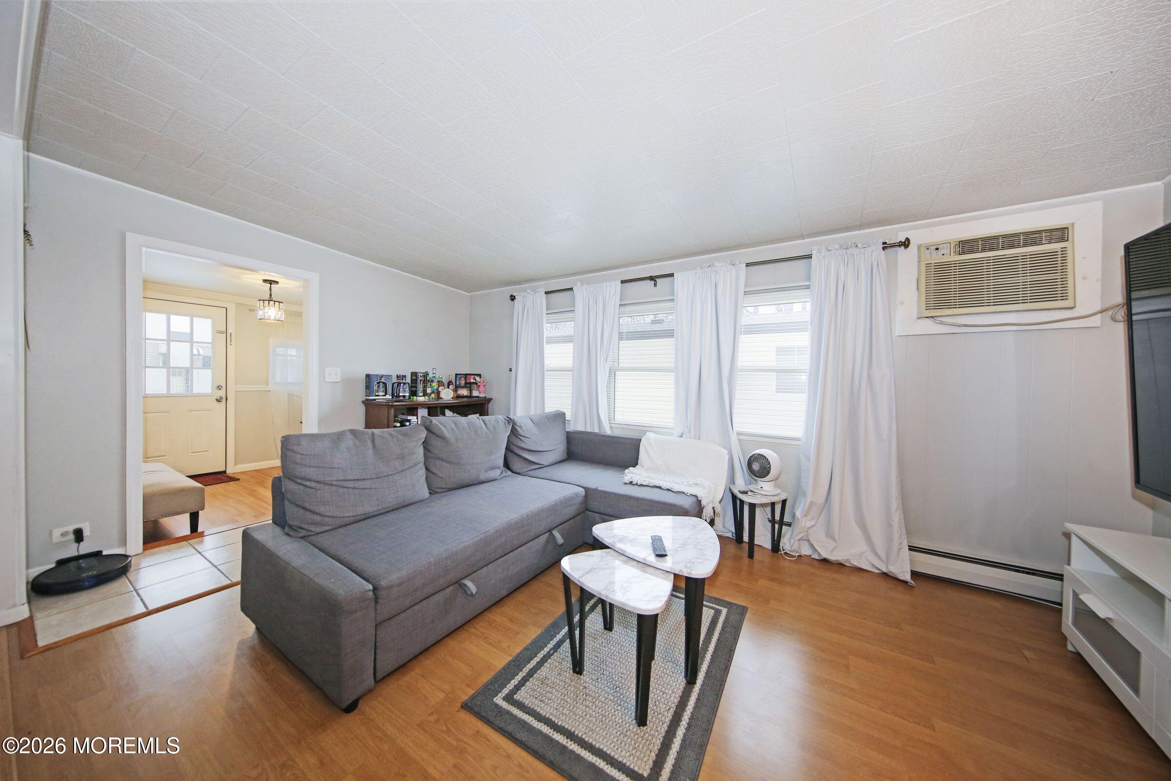 14 Monique Circle Hazlet, NJ 07730 - Photo 15 of 23 a living room with furniture and a wooden floor