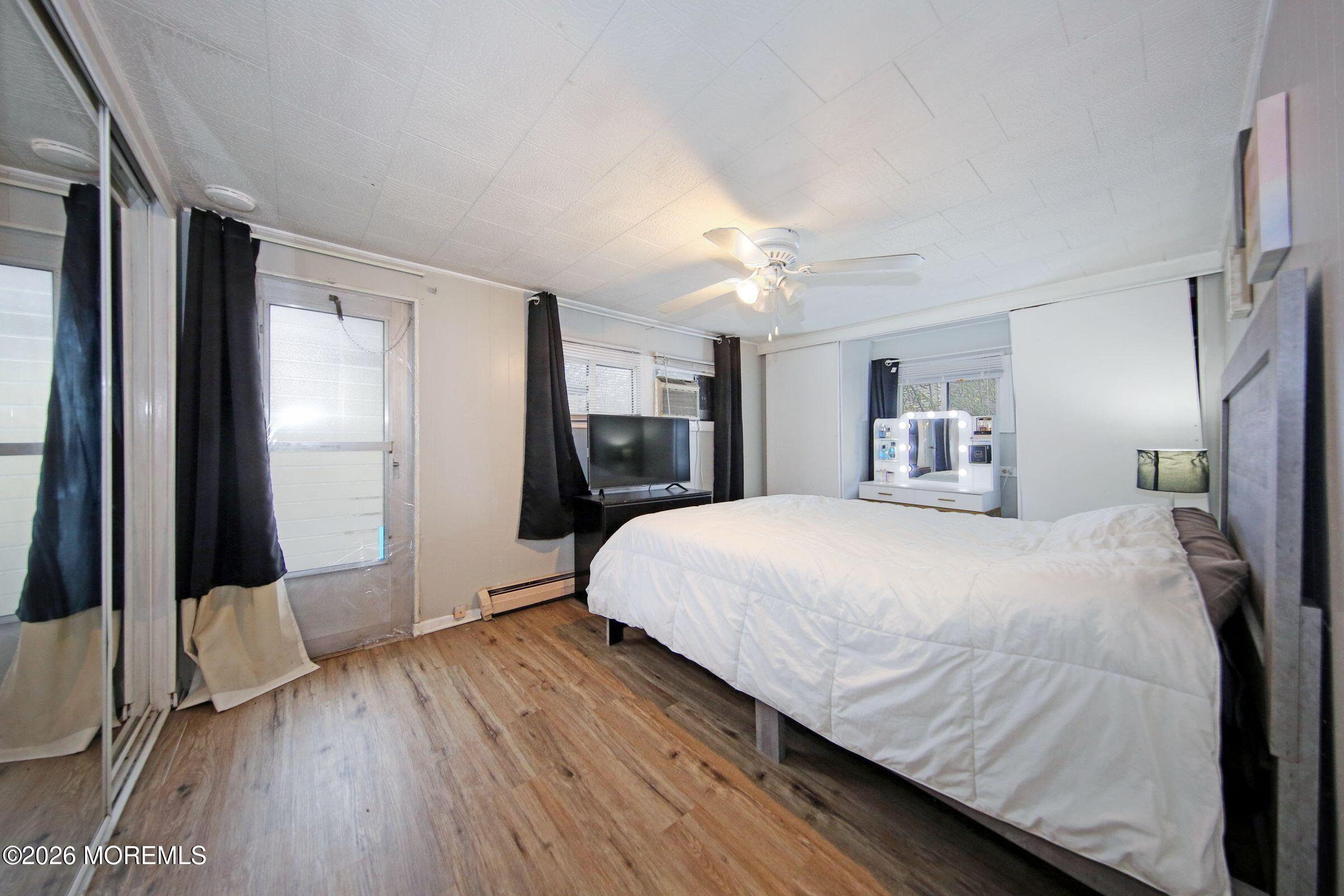 14 Monique Circle Hazlet, NJ 07730 - Photo 18 of 23 a spacious bedroom with a bed and a flat screen tv