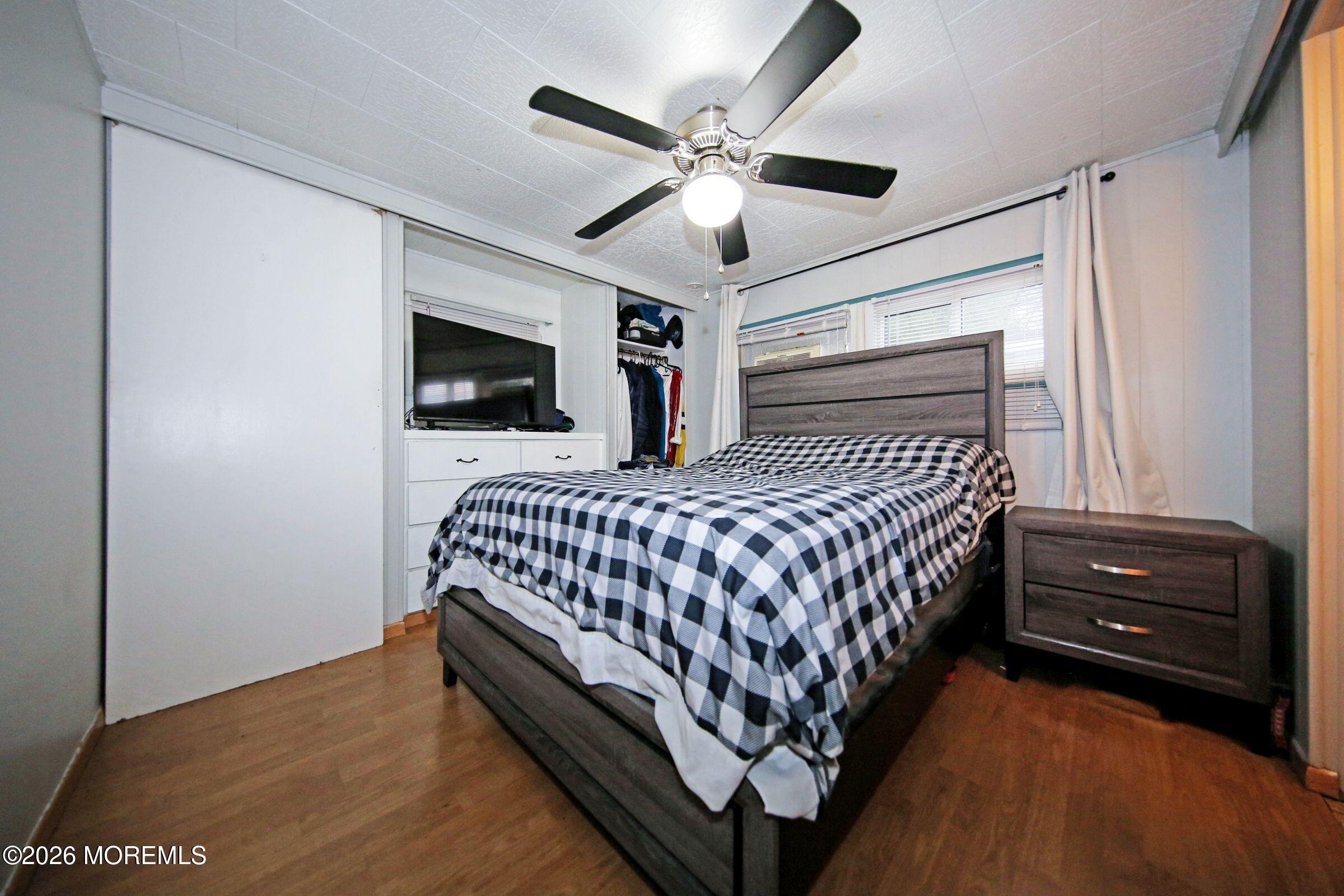 14 Monique Circle Hazlet, NJ 07730 - Photo 20 of 23 a bedroom with a bed window and a ceiling fan