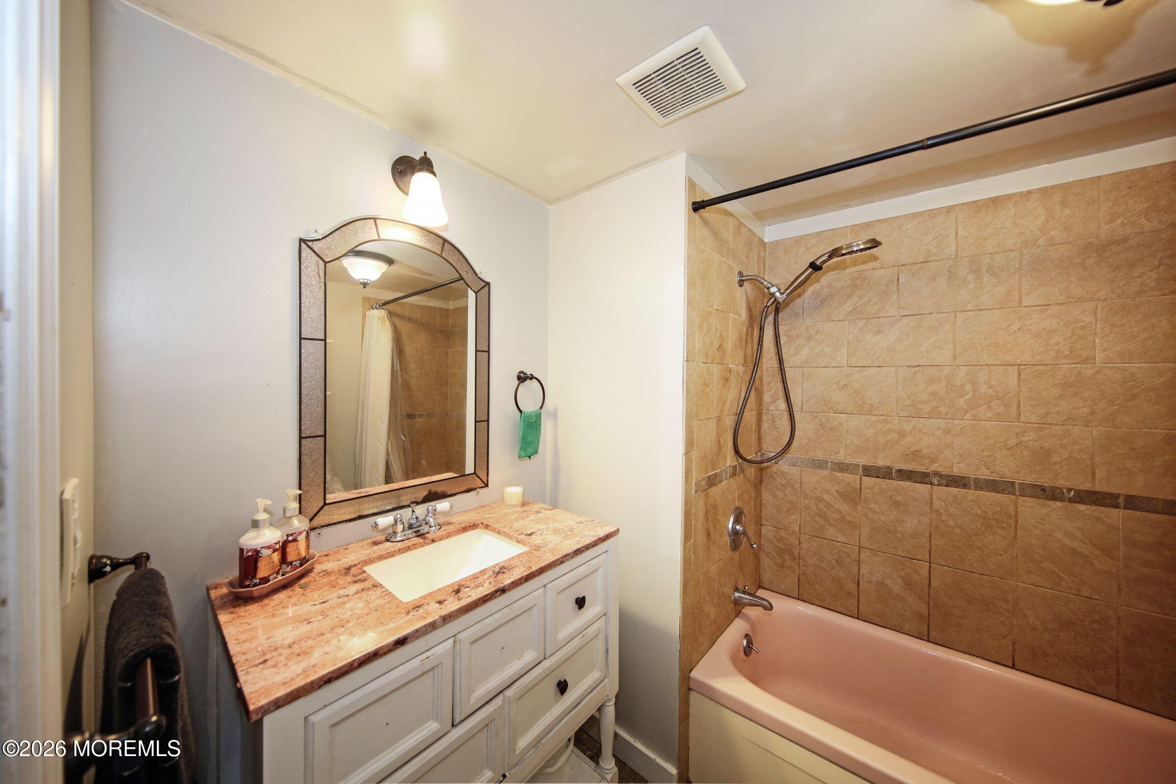 14 Monique Circle Hazlet, NJ 07730 - Photo 21 of 23 a bathroom with a granite countertop sink mirror and a bathtub