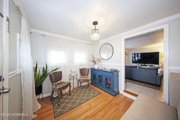 a living room with furniture a rug and a mirror