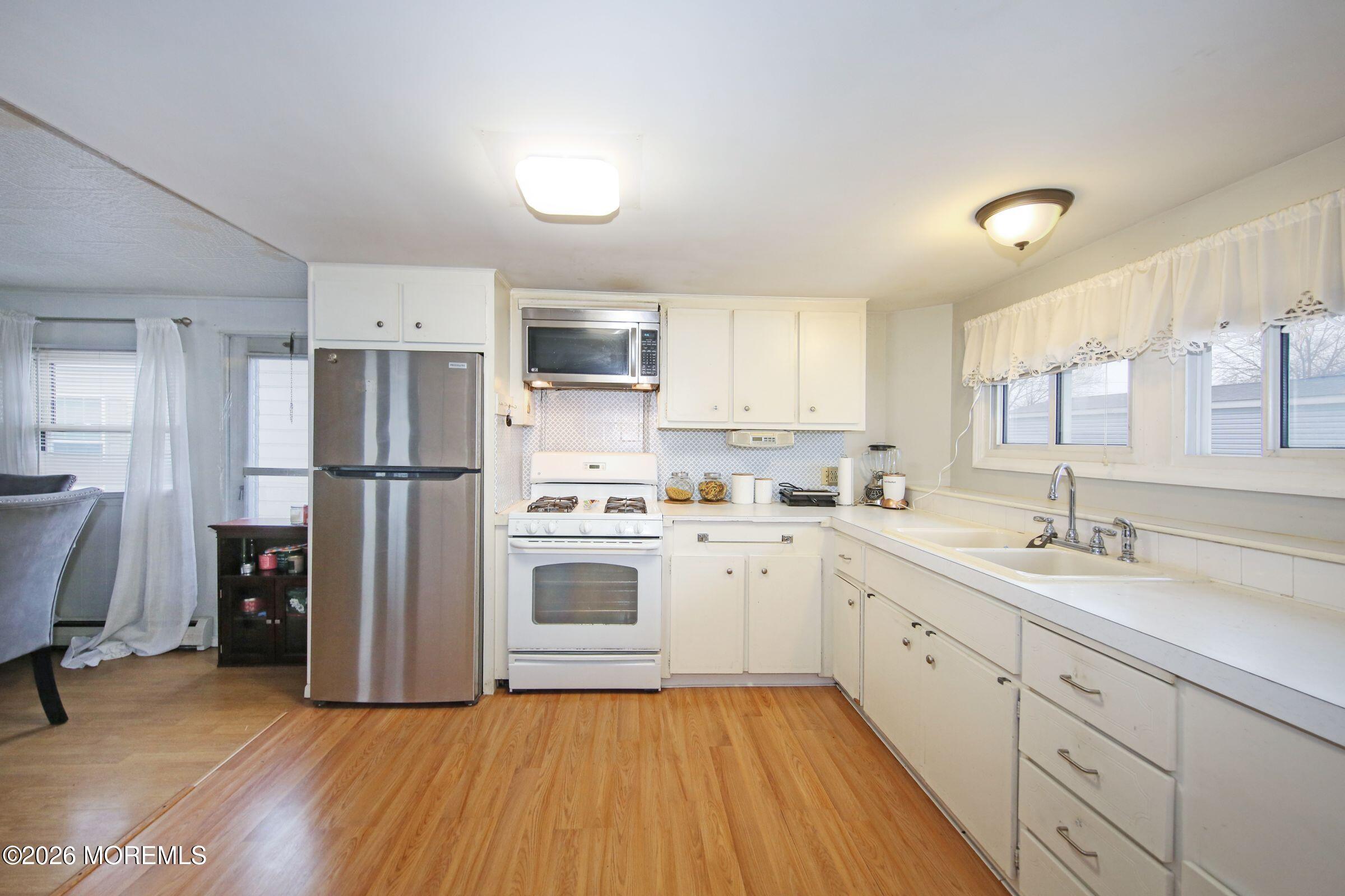 14 Monique Circle Hazlet, NJ 07730 - Photo 7 of 23 a kitchen with a refrigerator a sink and dishwasher