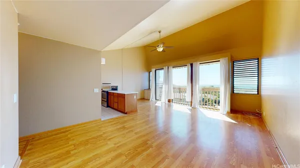 a big room with wooden floor and windows