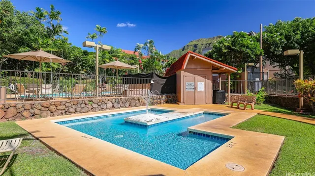 a view of a house with swimming pool and sitting area