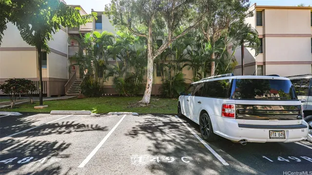 a view of a street with car parked on the road