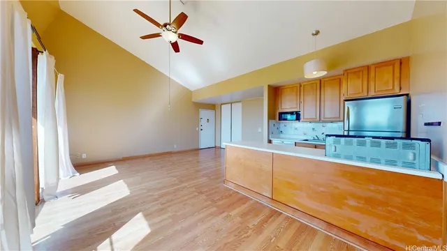 a view of a kitchen with kitchen island wooden floor and window