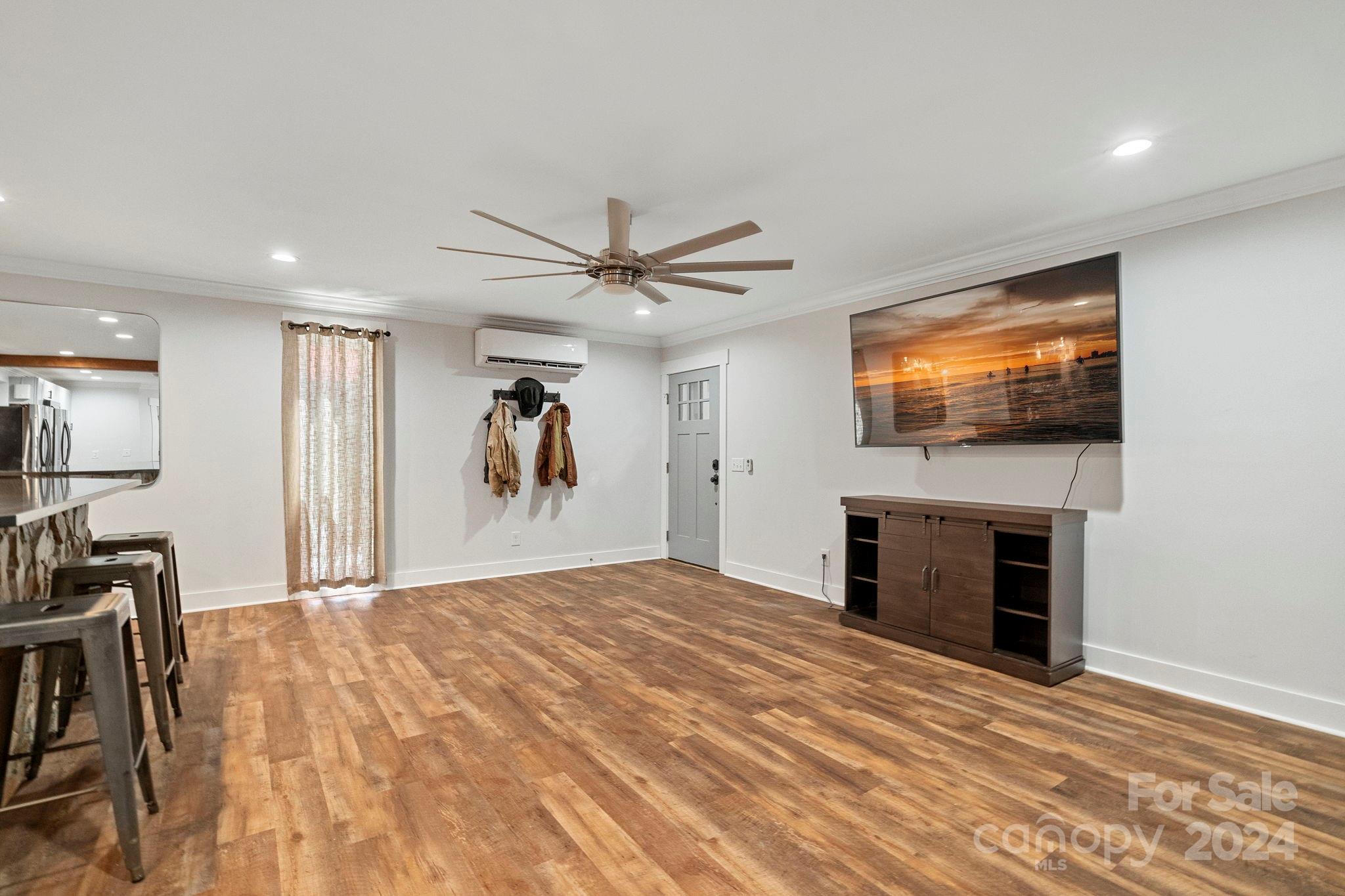 1198 Garvin Road York, SC 29745 - Photo 33 of 45 a view of a livingroom with a flat screen tv wooden floor and a ceiling fan