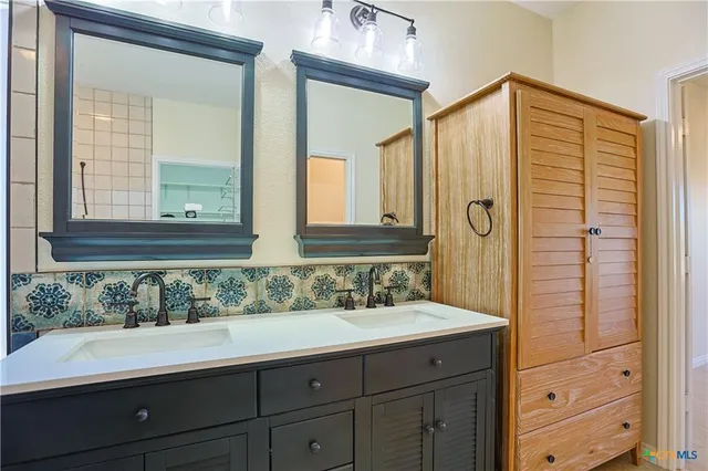 a bathroom with a sink and a mirror