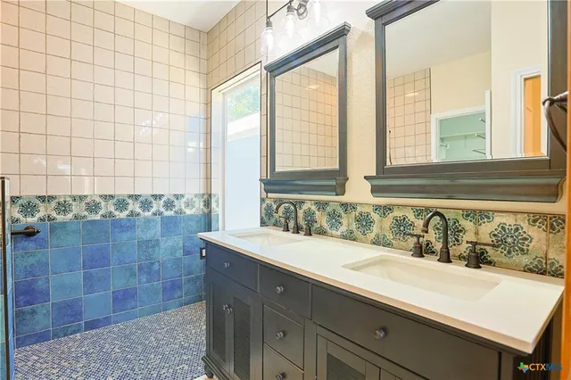 a bathroom with a sink and a large mirror