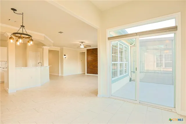 a view of a room with an empty space and windows