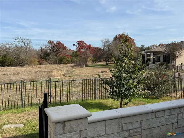a view of a bench in front of a yard