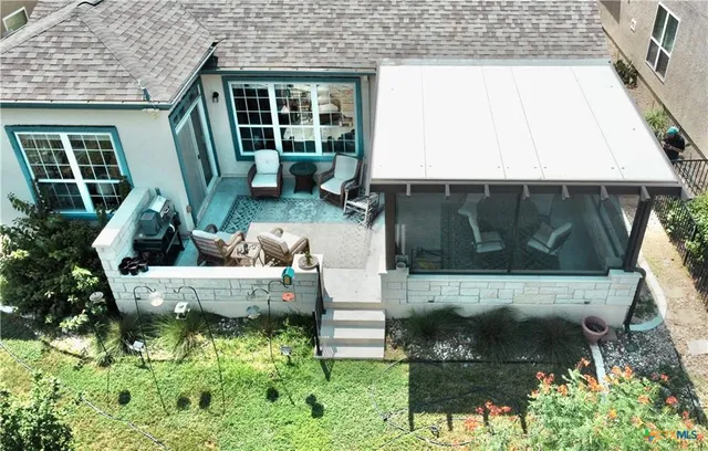 a view of a small house with pool yard fire pit and outdoor seating