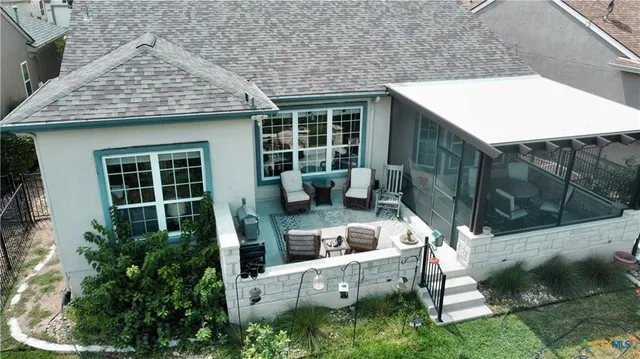 a view of house with backyard outdoor seating and plants