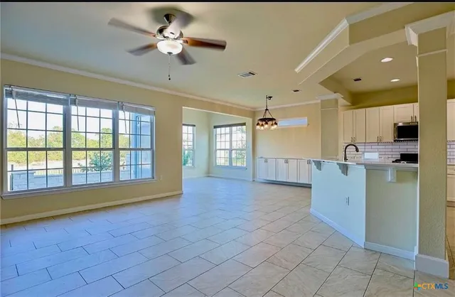 a view of an empty room with a kitchen