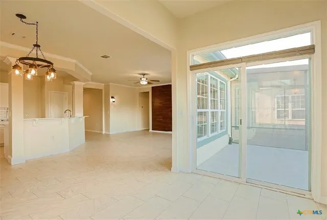 a view of a hallway with wooden floor and a bathroom