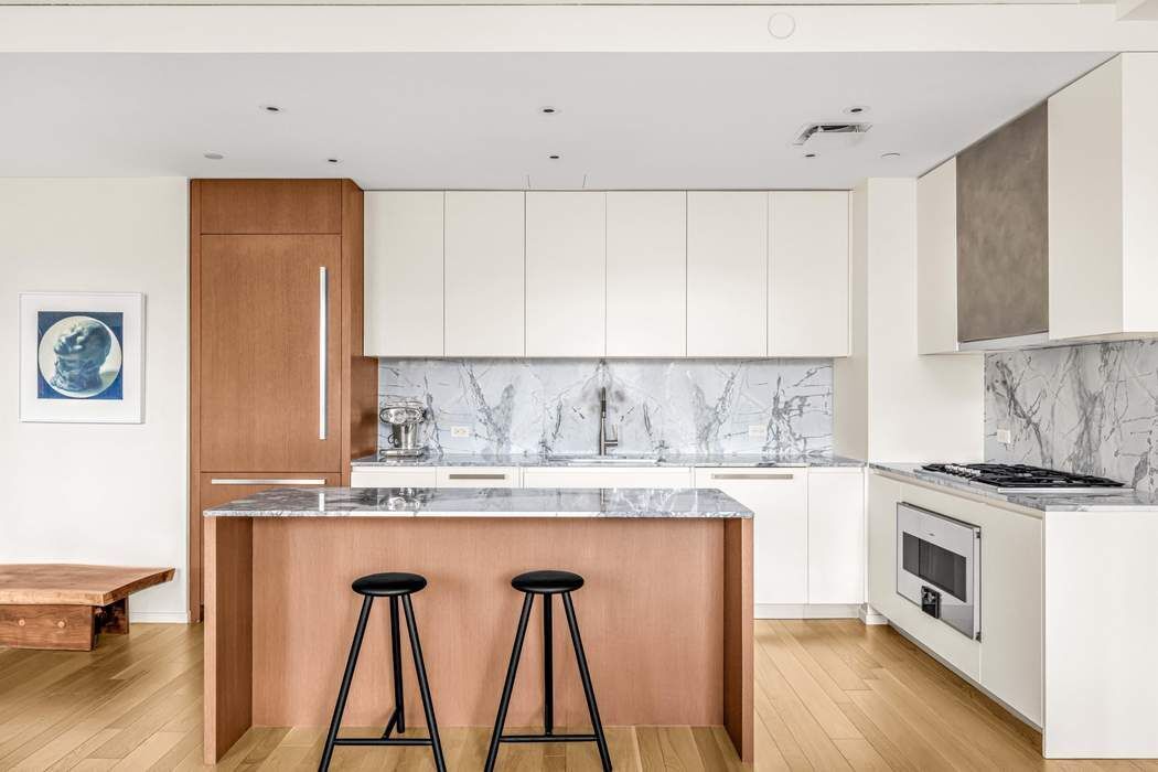 75 Kenmare Street, Unit 6B Manhattan, NY 10012 - Photo 5 of 11 a kitchen with a stove a sink and a refrigerator